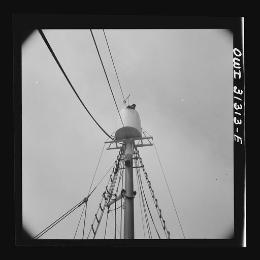 Untitled photo, possibly related to: Frank Mineo, owner of the Alden, climbs to the crow's nest to sight the mackerel school. Gloucester, Massachusetts