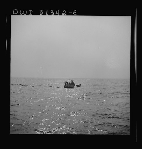 On board the fishing boat Alden, out of Glocester, Massachusetts. Gloucester fishermen pulling in their nets late in the evening