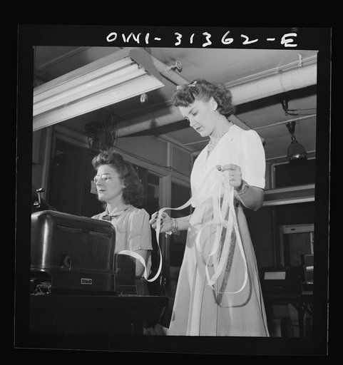 Washington, D.C. Preparing an advisory forecast at the U.S. Weather Bureau. Weather forecasts data are put on coding tape to transmission to various centers for dissemination and use in war activities