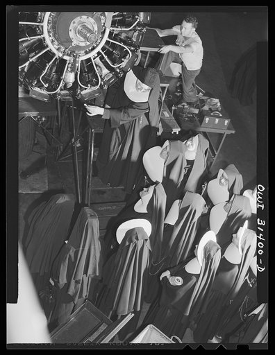 Washington, D.C. Field trips for the "flying nun" pre-flight class, including inspection tours of hangars at the Washington National Airport. Here, Sister Aquinas is explaining engine structure to her students