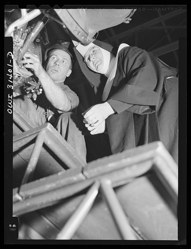 Washington, D.C. Sister Aquinas, "flying nun," exchanging trade secrets with an engineer at the Washington National Airport