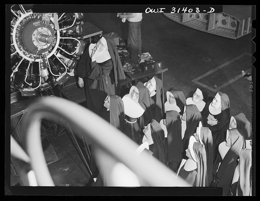 Untitled photo, possibly related to: Washington, D.C. Field trips for the "flying nun" pre-flight class, including inspection tours of hangars at the Washington National Airport. Here, Sister Aquinas is explaining engine structure to her students