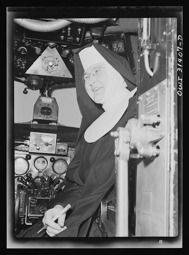 Untitled photo, possibly related to: Washington, D.C. Sister Aquinas, "flying nun," exchanging trade secrets with an engineer at the Washington National Airport