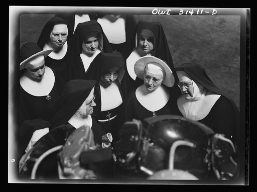 Untitled photo, possibly related to: Washington, D.C. Field trips for the "flying nun" pre-flight class, including inspection tours of hangars at the Washington National Airport. Here, Sister Aquinas is explaining engine structure to her students