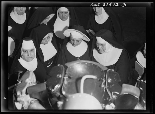 Untitled photo, possibly related to: Washington, D.C. Field trips for the "flying nun" pre-flight class, including inspection tours of hangars at the Washington National Airport. Here, Sister Aquinas is explaining engine structure to her students