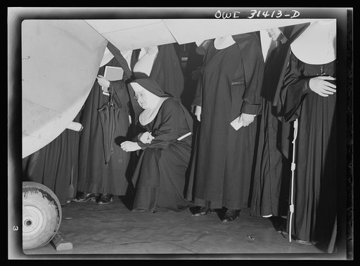 Untitled photo, possibly related to: Washington, D.C. Field trips for the "flying nun" pre-flight class, including inspection tours of hangars at the Washington National Airport. Here, Sister Aquinas is explaining engine structure to her students