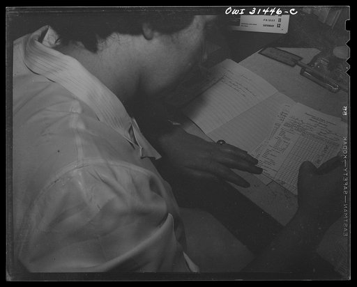 Untitled photo, possibly related to: Schenectady, New York. Third grader at the Elmer Avenue Elementary School writing a story on Children's Day. The open notebook is a personal speller