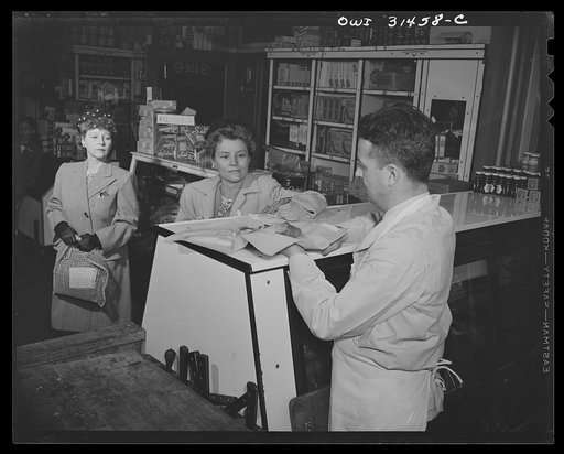 Two women and a butcher at a meat counter, in a scene from "Black Marketing," a motion picture produced by the U.S. Office of War Information (OWI) and released on August 19, 1943