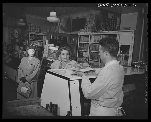 Two women and a butcher at a meat counter, in a scene from "Black Marketing," a motion picture produced by the U.S. Office of War Information (OWI) and released on August 19, 1943