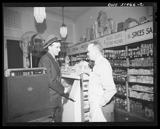 A butcher and a patron at the meat counter of a grocery store, a scene from "Black Marketing," a film produced by the U.S. Office of War Information (OWI) and released August 19, 1943