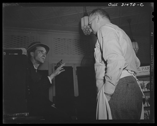 A butcher and a patron, in a scene in "Black Marketing," a motion picture being made by the U.S. Office of War Information (OWI). It will be released in August, 1943