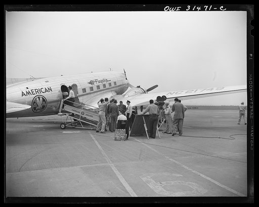 A scene at the American Airlines "Flagship" passenger plane, showing moving picture and sound equipment being used during the filming of "Black Marketing," a motion picture produced by the U.S. Office of War Information (OWI) and released August 19, 1943