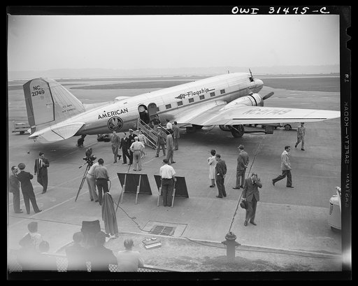 Photographers of the U.S. Office of War Information (OWI) filming a scene at the American Airlines "Flagship" passenger plane, for the motion picture "Black Marketing." The film was released by the OWI on August 19, 1943