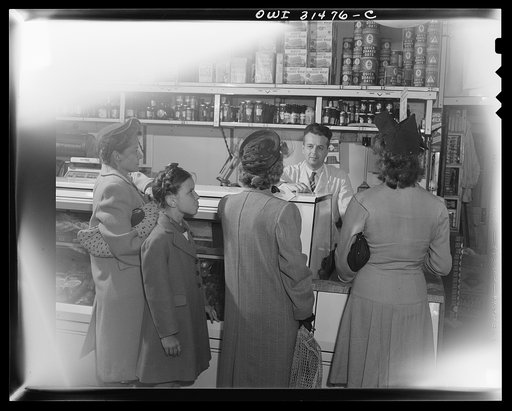 Customers waiting for the butcher in a grocery store, in a scene during the filming of "Black Marketing," a motion picture produced by the U.S. Office of War Information (OWI) and released August 19, 1943