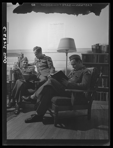 Oswego, New York. A Chinese in the U.S. Army and two American soldiers reading in the Oswego USO (United Service Organizations) club