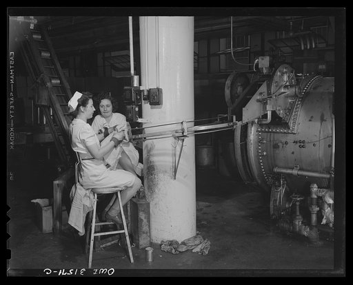 Cincinnati, Ohio. Preparing canned pork (Russian: "Svinaia tushonka") for lend-lease shipment to the USSR at the Kroger grocery and baking company. Inspecting the cans of pork as they come out of the pressure cooker where the pork is cooked for two and one-half hours at 160 to 250 degrees