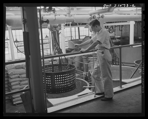 Cincinnati, Ohio. Preparing canned pork (Russian: "svinaia tushonka") for lend-lease shipment to the USSR at the Kroger grocery and baking company. Removing pork after it has been cooked for the twenty percent pre-shrinkage and eight minutes at 180 degrees