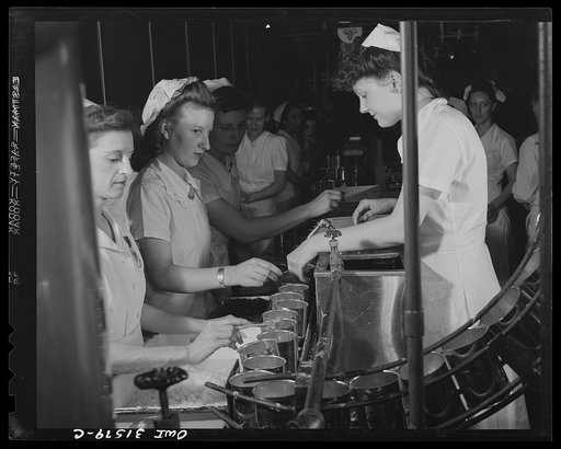 Cincinnati, Ohio. Preparing canned pork (Russian: "svinaia tushonka") for lend-lease shipment to the USSR at the Kroger grocery and baking company. Girls placing lard, spice and onions in cans before the pork is added. Right: Bonnie Williams, age twenty-one, who formerly worked in a shirt factory, h