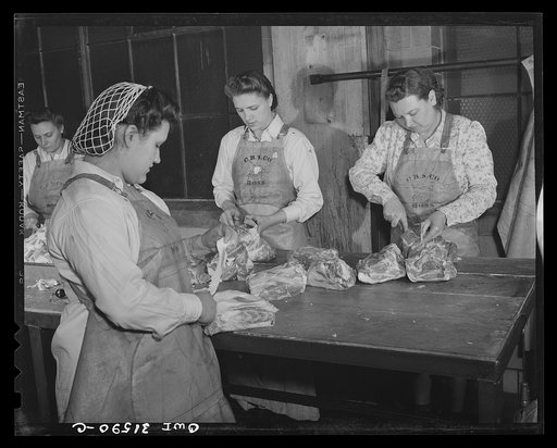 Cincinnati, Ohio. Preparing canned pork (Russian: "svinaia tushonka") for lend-lease shipment to the USSR at the Kroger grocery and baking company. Girls removing fat and bones from pork before cutting it down to size for pre-shrinkage