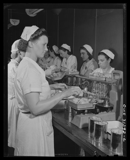 Untitled photo, possibly related to: Cincinnati, Ohio. Preparing canned pork for lend-lease shipment to USSR. Kroger Company. Tins of pork on packing line