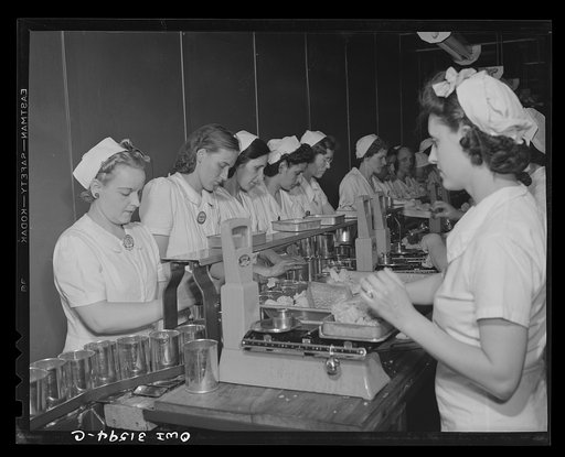 Cincinnati, Ohio. Preparing canned pork (Russian: "svinaia tushonka") for lend-lease shipment to the USSR at the Kroger grocery and baking company. Tins of pork on the packing line