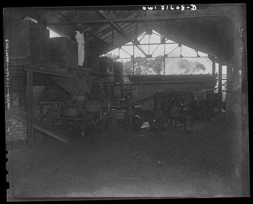 Trechot Trading Company palm oil factory at Etoumbi, Moyen Congo bush, French Equatorial Africa. General view of the oil presses below the hoppers
