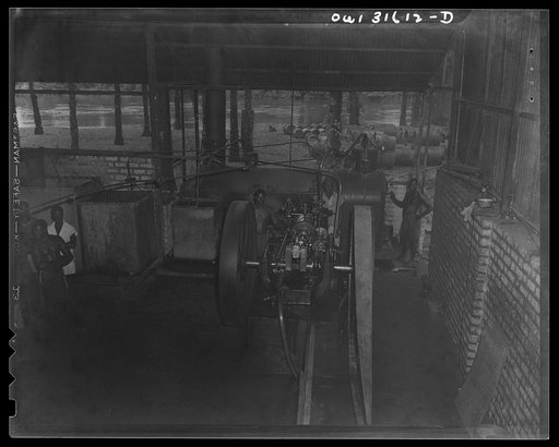 Trechot Trading Company palm oil factory at Etoumbi, Moyen Congo bush, French Equatorial Africa. Seperated kernels are stored in these vats until ready for shipment. They go to England and America to make oleomargarine and other foodstuff