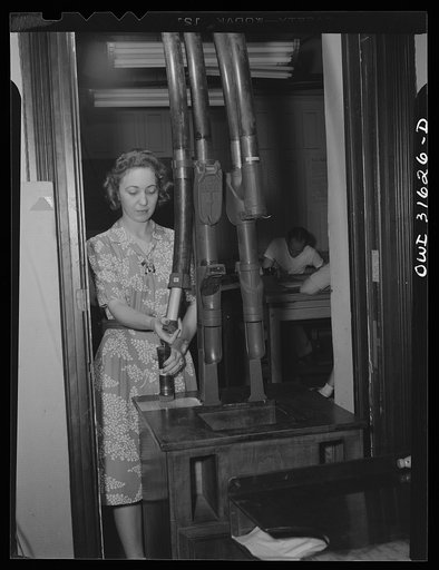 Washington, D.C. Preparing an advisory forecast at the U.S. Weather Bureau. Completed weather information is sent by pneumatic tubes to a communication center for transmittal to various military and civilian centers for war activity use