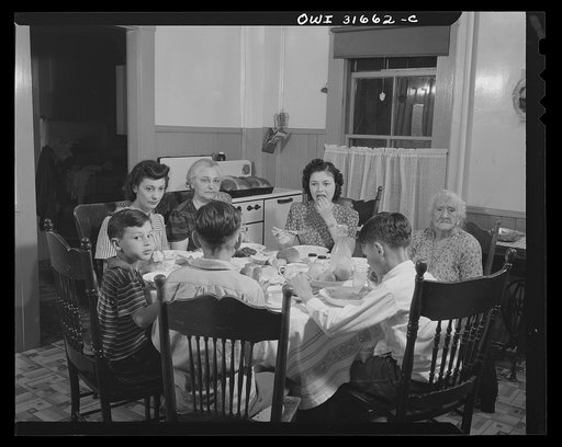 Untitled photo, possibly related to: Gloucester, Massachusetts. Mrs. Isabell Lopez, her mother, children and grandchildren having dinner. Mr. Lopez, is a fish skinner at Gorton-Pew Fisheries. With the exception of one day a week, he is working at dinner time