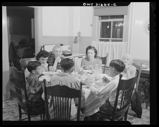 Gloucester, Massachusetts. Mrs. Isabell Lopez, her mother, children and grandchildren having dinner. Mr. Lopez, is a fish skinner at Gorton-Pew Fisheries. With the exception of one day a week, he is working at dinner time