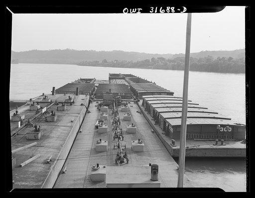 Gallipolis, Ohio. Barges as seen from the pilot house of the towboat Charles T. Campbell on the way down the Ohio River to Cincinnati. Oil barges are in the near foreground