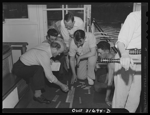 Gallipolis, Ohio. Pilots and mates of the Ernest T. Weir, a towboat, using wooden blocks to make up the arrangement of barges