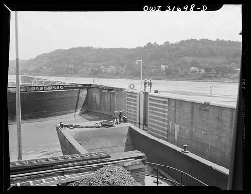 Gallipolis, Ohio. The deck hands of the towboat Charles T. Campbell lashing the towboat to the side of the locks because double locking is necessary when the tow is so long. The barges go through first and then the towboat