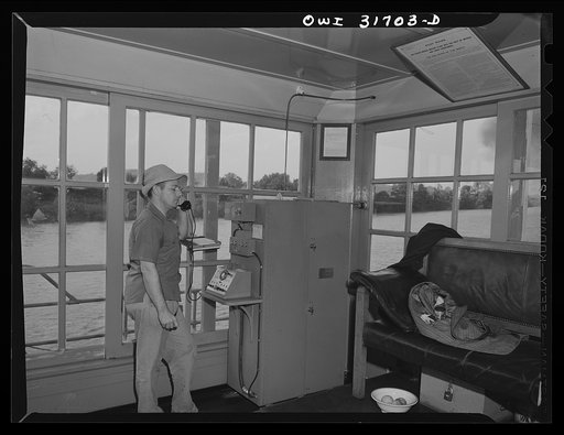 The pilot talking on the ship to shore telephone aboard the Charles T. Campbell, a towboat going down the Ohio River