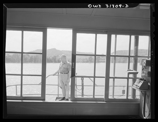 The side of the pilot house of the towboat Ernest T. Weir going down the Ohio River to Cincinnati
