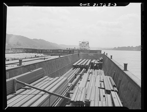 The cargo of steel girders in a barge going down the Ohio River to Cincinnati