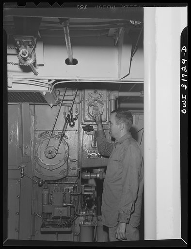 One of the crew in the engine room of the towboat Ernest T. Weir on the way to Cincinnati down the Ohio River
