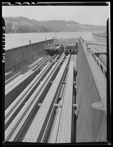 Steel girders in a barge being towed by the towboat Ernest T. Weir down the Ohio River to Cincinnati