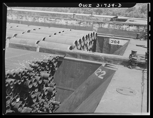 Barges loaded with piping and gas containers in the tow of the towboat Ernest T. Weir going down the Ohio River to Cincinnati