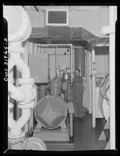 One of the crew in the engine room of the towboat Ernest T. Weir going down the Ohio River to Cincinnati