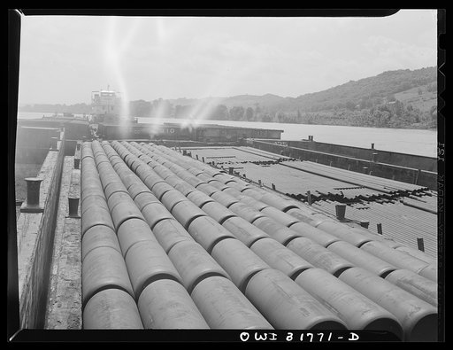 Untitled photo, possibly related to: Gas containers piled in a barge in the tow of the Ernest T. Weir going down the Ohio River to Cincinnati