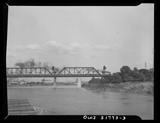 Cincinnati, Ohio. A train crossing the Cincinnati bridge as seen from the towboat Ernest T. Weir on the Ohio River