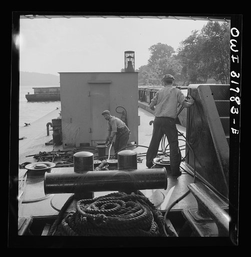 Deckhands at work with cable and ropes aboard in the towboat Ernest T. Weir going down the Ohio River to Cincinnati