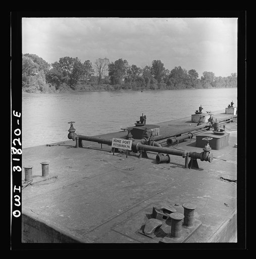 Detail of an oil barge in the tow of the towboat Ernest T. Weir going down the Ohio River to Cincinnati