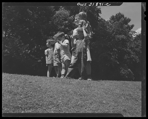 New Britain, Connecticut. A child care center, opened September 15, 1942, for thirty children, age two to five, of mothers engaged in war industry. The hours are 6:30 a.m. to 6 p.m., six days per week. Miss Jane Machmer and some of the children whose mothers are press operators, stenographers, drill