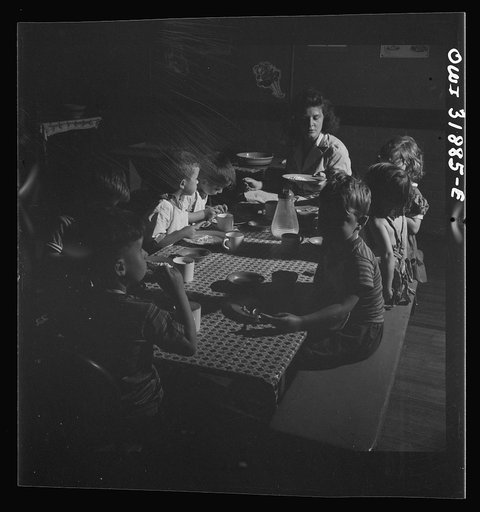 Untitled photo, possibly related to: New Britain, Connecticut. A child care center, opened September 15, 1942, for thirty children, aged two to five, of mothers engaged in war industry. The hours are 6:30 a.m. to 6 p.m., six days per week. Children having lunch with a trained assistant