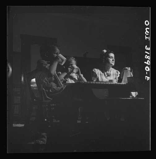 Untitled photo, possibly related to: New Britain, Connecticut. A child care center, opened September 15, 1942, for thirty children, aged two to five, of mothers engaged in war industry. The hours are 6:30 a.m. to 6 p.m., six days per week. Children having lunch with a trained assistant
