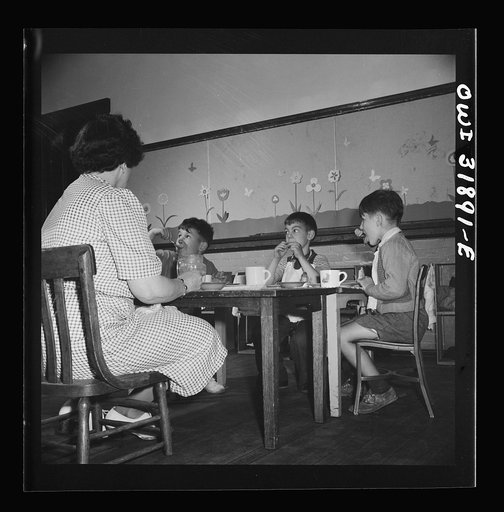 New Britain, Connecticut. A child care center, opened September 15, 1942, for thirty children, aged two to five, of mothers engaged in war industry. The hours are 6:30 a.m. to 6 p.m., six days per week. Children having lunch with a trained assistant