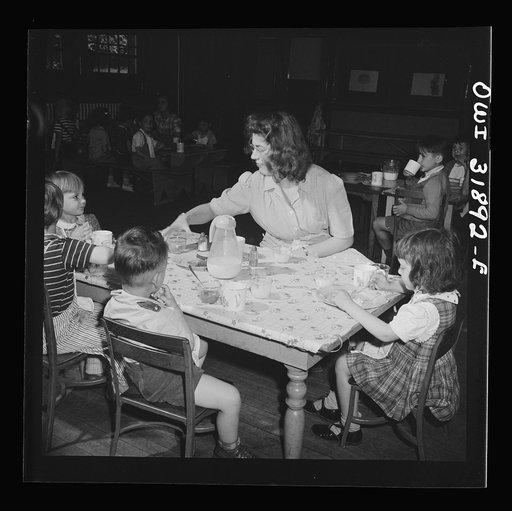 New Britain, Connecticut. A child care center, opened September 15, 1942, for thirty children, aged two to five, of mothers engaged in war industry. The hours are 6:30 a.m. to 6 p.m., six days per week. Children having lunch with a trained assistant