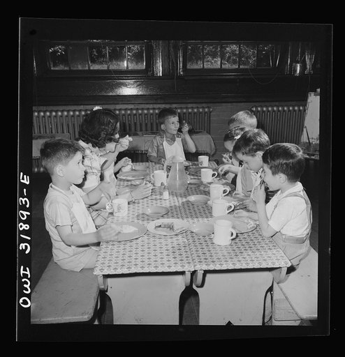 New Britain, Connecticut. A child care center, opened September 15, 1942, for thirty children, aged two to five, of mothers engaged in war industry. The hours are 6:30 a.m. to 6 p.m., six days per week. Children having lunch with a trained assistant